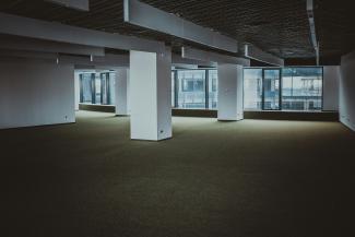 empty brown and white building by Sergei Wing courtesy of Unsplash.