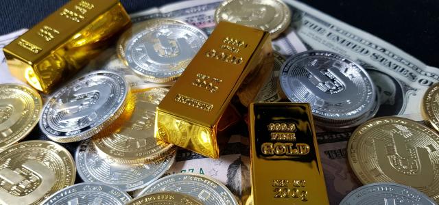 a pile of gold bars sitting on top of a pile of money by Dash Cryptocurrency courtesy of Unsplash.