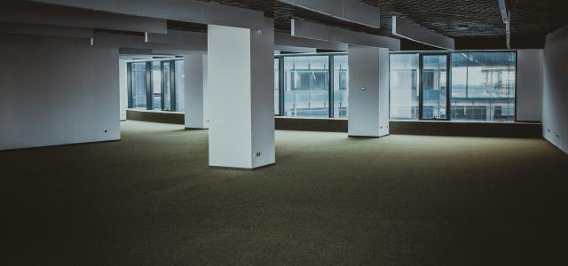 empty brown and white building by Sergei Wing courtesy of Unsplash.